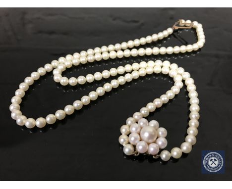 A pearl and 9ct gold double strand necklace 