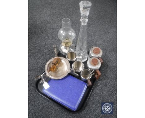A tray of mid 20th century stainless steel tea service, cased cutlery, glass decanter, oil lamp, plated candle holder raised 
