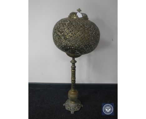 An Eastern brass table lamp with ball shade 