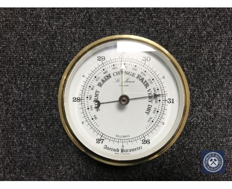 A brass cased circular barometer