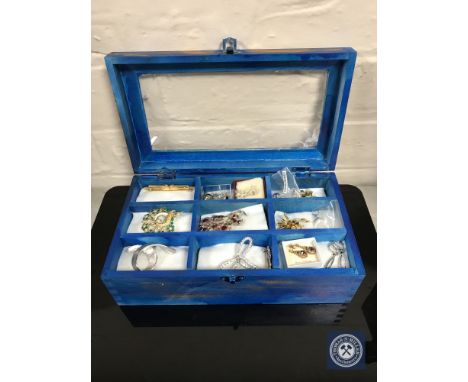A box of costume brooches and 9ct gold earrings 