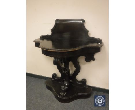 A late Victorian carved console table, width 96 cm.