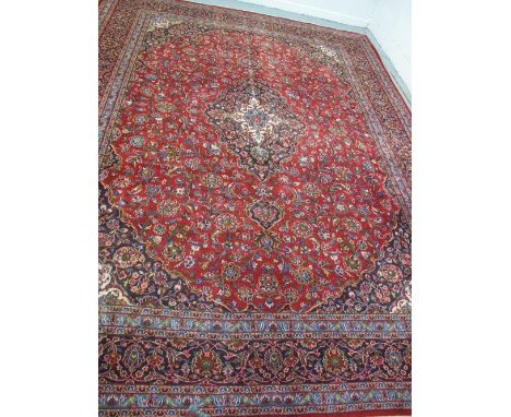 LARGE PERSIAN RED GROUND FOLIATE CARPET. 290 x 300cm approx. (B.P. 24% incl. VAT)   CONDITION REPORT:  Rather low in places, 
