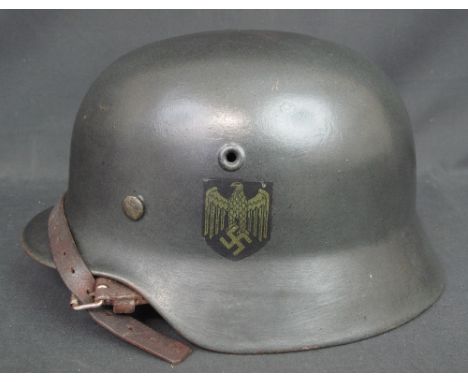 A GERMAN WERMACHT STYLE SECOND WORLD WAR TYPE SINGLE DECAL M35 STEEL HELMET, the outer shell with single eagle swastika decal