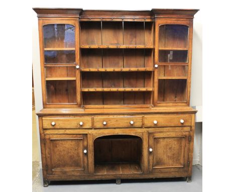 19TH CENTURY OAK DOG KENNEL DRESSER, the raised back having moulded cornice over three centre shelves, flanked by two glazed 