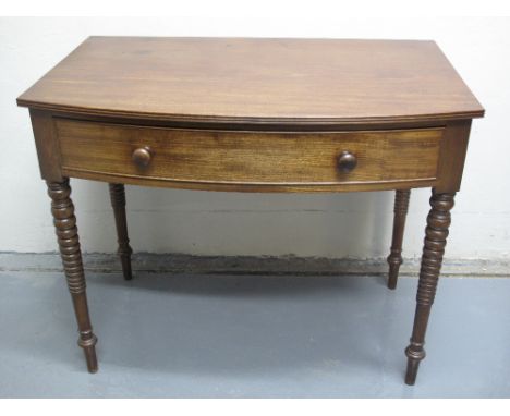 19TH CENTURY MAHOGANY BOW FRONTED SIDE TABLE, having reeded edged top over cock beaded frieze drawer with turned knobs, stand