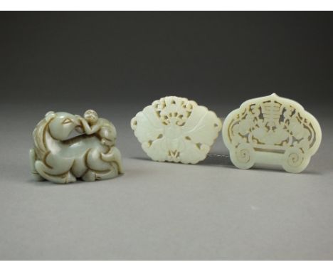 Two Chinese jade pendants, the first pale celadon and of ruyi form, carved with a bat flanked by lotus flowers beneath a shou