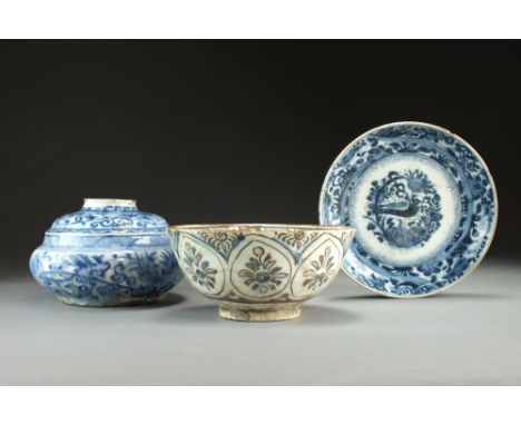 Three Persian pottery pieces, Iran 17th Century, the first a 'Kubachi' type bowl decorated with repeating panels of stylised 