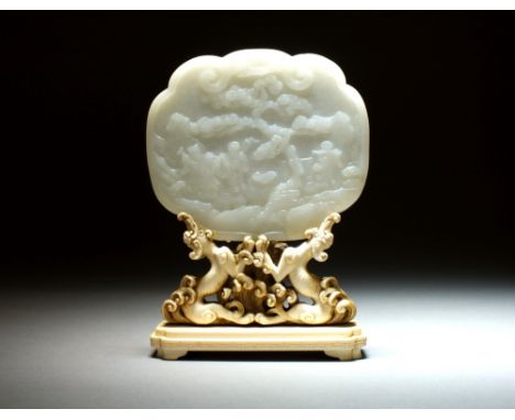 A Chinese nephrite jade panel, Qing Dynasty, possibly originally a box cover, of ruyi form and carved in low relief with a sc