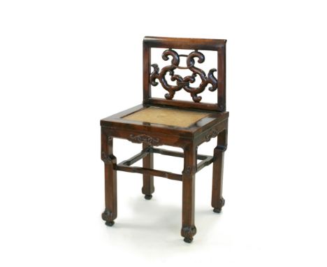 A Chinese hardwood child's chair, 19th Century, the roll-top back with double-scroll carved splat, the seat inlaid with woven