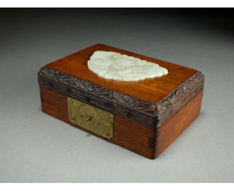 A Chinese jade inset rosewood card box, 19th/20th Century, of rectangular form, the hinged top inset with a pale green nephri