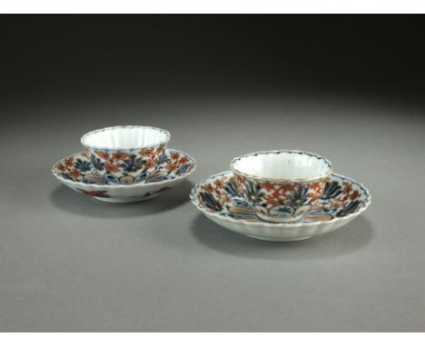 A pair of Japanese Imari teabowls and saucers, 18th Century, of lobed form and decorated with stylised flowers and foliage in