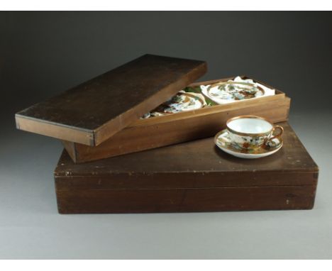 A cased set of Japanese Kutani teacups and saucers, Taisho period, decorated with figures in rural landscapes, comprising ele