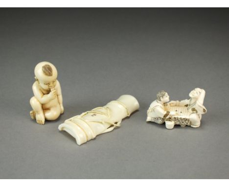 Two Japanese ivory netsuke, Meiji period, the first modelled as a man and boy playing go, 5cm long, the second carved as an i