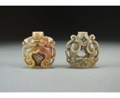 Two Chinese carved soapstone snuff bottles, 18th/19th Century, of ovoid form with scroll handles and motifs around reticulate