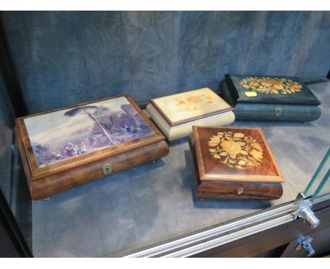 Two modern Swiss inlaid music boxes, a similar Sorrento music box, and another music box with a print to the lid (4) 