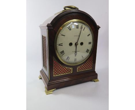 A George III mahogany cased bracket clock, the arched case with brass fittings and fretwork enclosing a painted dial inscribe