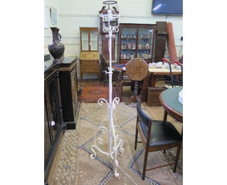 A painted wrought iron standard lamp, of scrolling form with tripod base, 158 cm high 