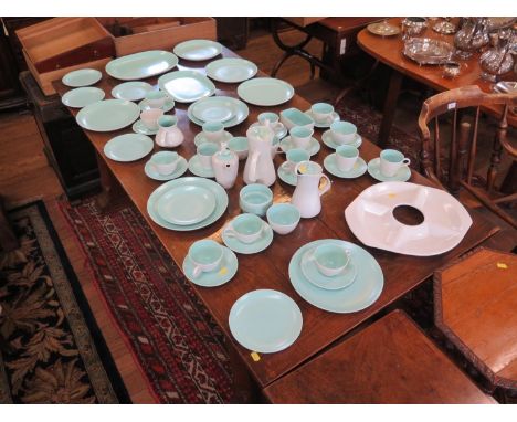 A Poole Pottery Twin Tone part tea service, in green, and a similar plain green Poole Pottery part dinner service, 56 pieces 