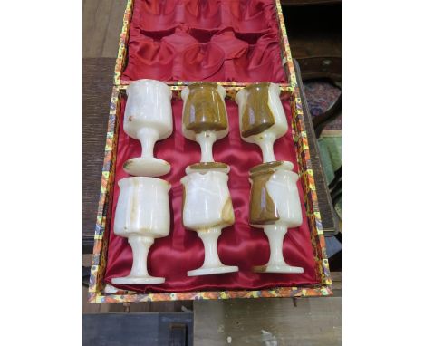 A set of six onyx goblets, 12.5 cm high, cased, one chipped, a pair of gilt metal wall lights, a jade cigar cutter and variou