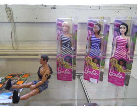 An Action Man Moon Raker, orange and grey bike, four figure dolls and three Barbie Dolls 