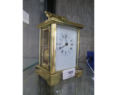 A brass carriage clock, of conventional form with enamelled dial, the twin train movement striking on a bell, 17 cm high (han