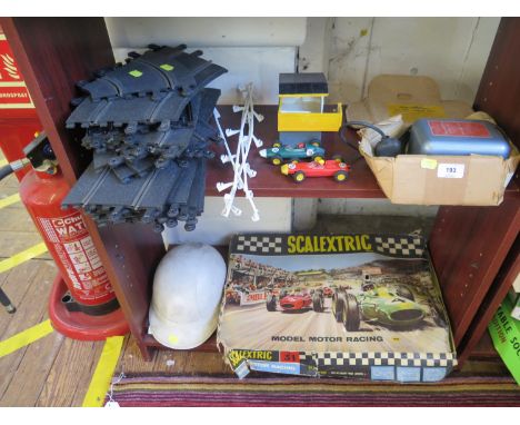 A Scalextric set 31 and a size 6 7/8 racing helmet 