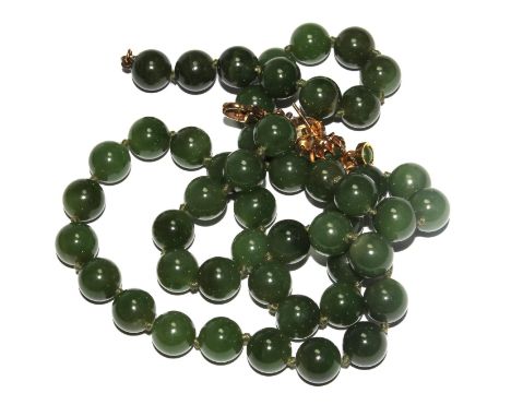 Two pairs of jade earrings and a jade necklace 