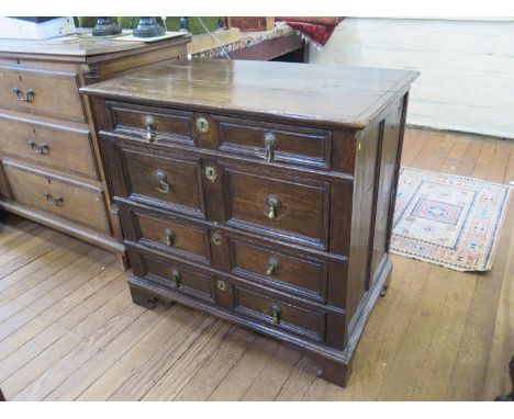 An early 18th oak chest of drawers, with four long graduated panelled drawers, with grooved linings, on later bracket feet, 8