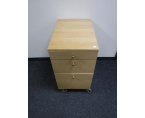 A light oak three drawer filing cabinet 