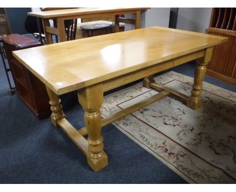 A high quality light oak refectory table 