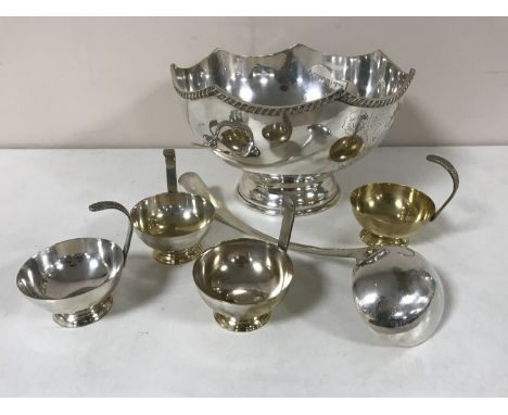 A silver plated punch bowl with ladle and cups CONDITION REPORT: Bowl 31cm in diameter. Tarnished somewhat and with a few min