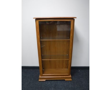 A light oak display cabinet 