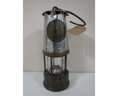 A vintage Protector miner's lamp