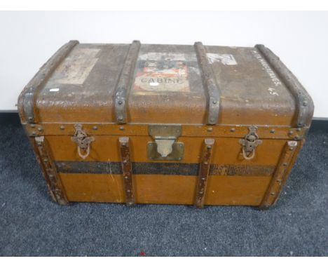 A vintage shipping trunk with shipping labels