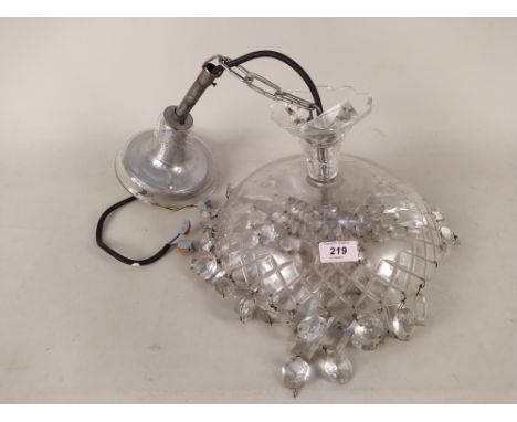 A cut glass hanging ceiling light with facet cut drops
