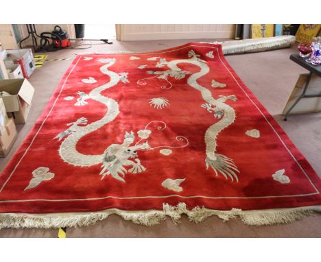 A large Chinese wool red ground carpet, 375cm x 270cm