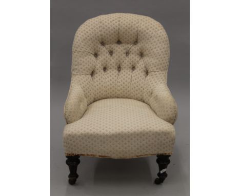 A cream upholstered button back Victoria nursing chair. 56 cm wide.