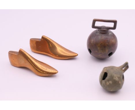 A miniature pair of bronze shoe lasts and two bells. The former 6.5 cm long.