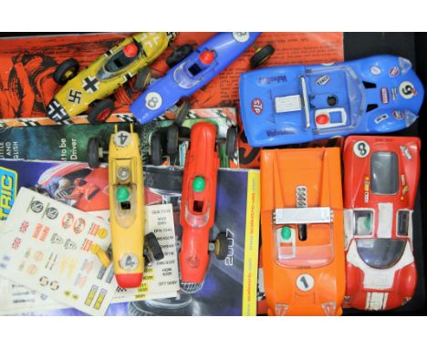 A box of vintage Scalextric and other slot cars. 