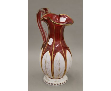 A Bohemian ruby overlaid glass ewer. 27 cm high.