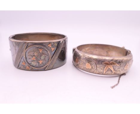 Two unmarked gold mounted silver bangle form bracelets. 