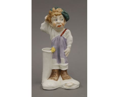 A Victorian porcelain golf caddy spill holder. 17 cm high.