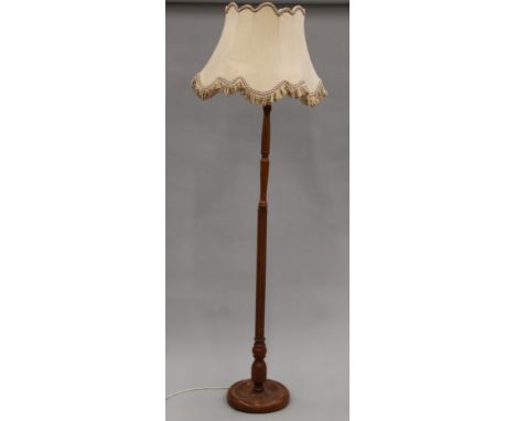 A oak standard lamp and shade. 188 cm high overall.
