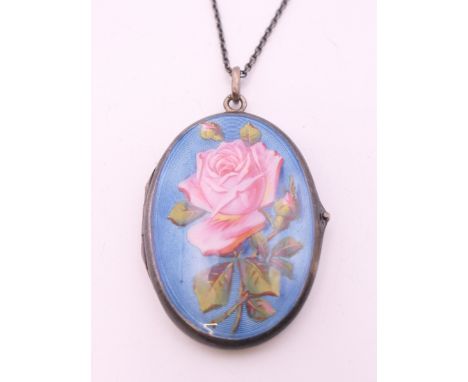 A silver and enamel locket on chain. The locket 4 cm high.