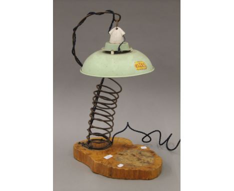 A vintage table lamp with green painted Eltex shade. 63 cm high overall.