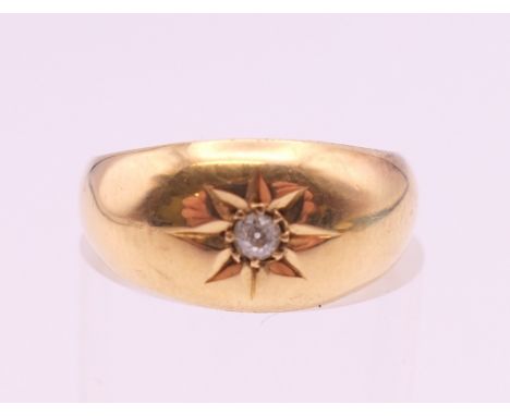 An 18 ct gold diamond gypsy set solitaire ring. Ring size J/K. 2.6 grammes total weight.