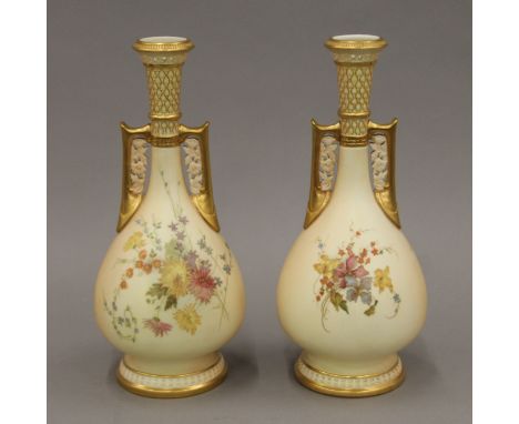 A pair of Royal Worcester florally painted blush ivory porcelain vases. 25 cm high.