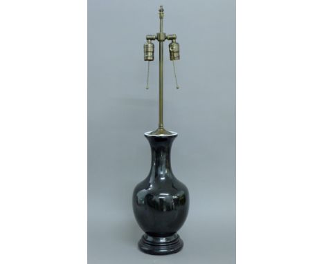 A Chinese black porcelain lamp. 81 cm high overall.