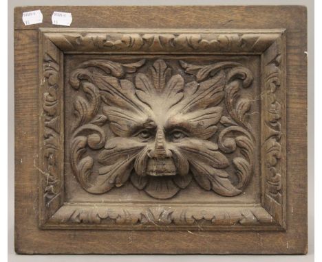 A Victorian carved oak panel depicting the Green Man. 37 cm wide.